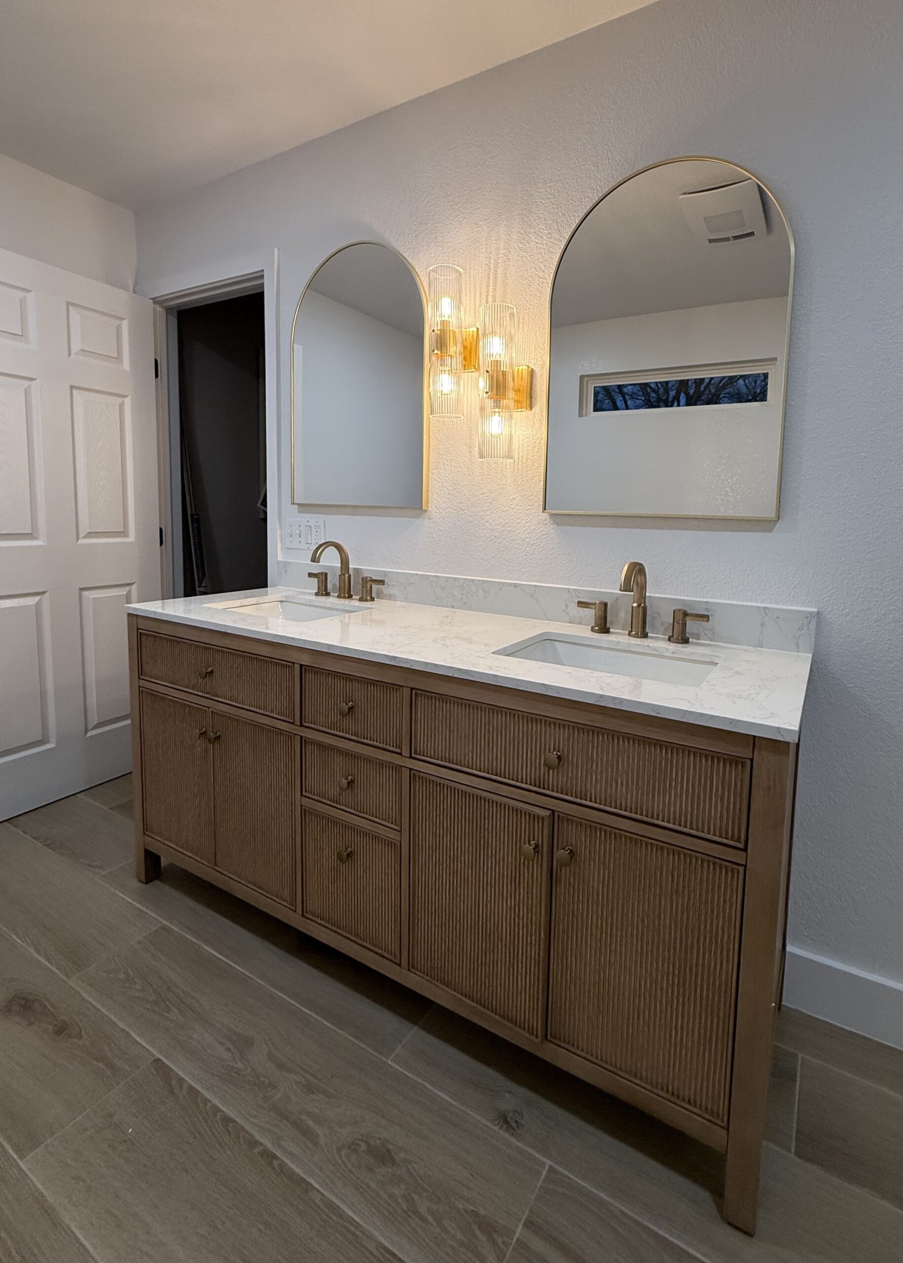 Bathroom remodel in San Antonio TX with updated vanity, tile flooring, and modern fixtures